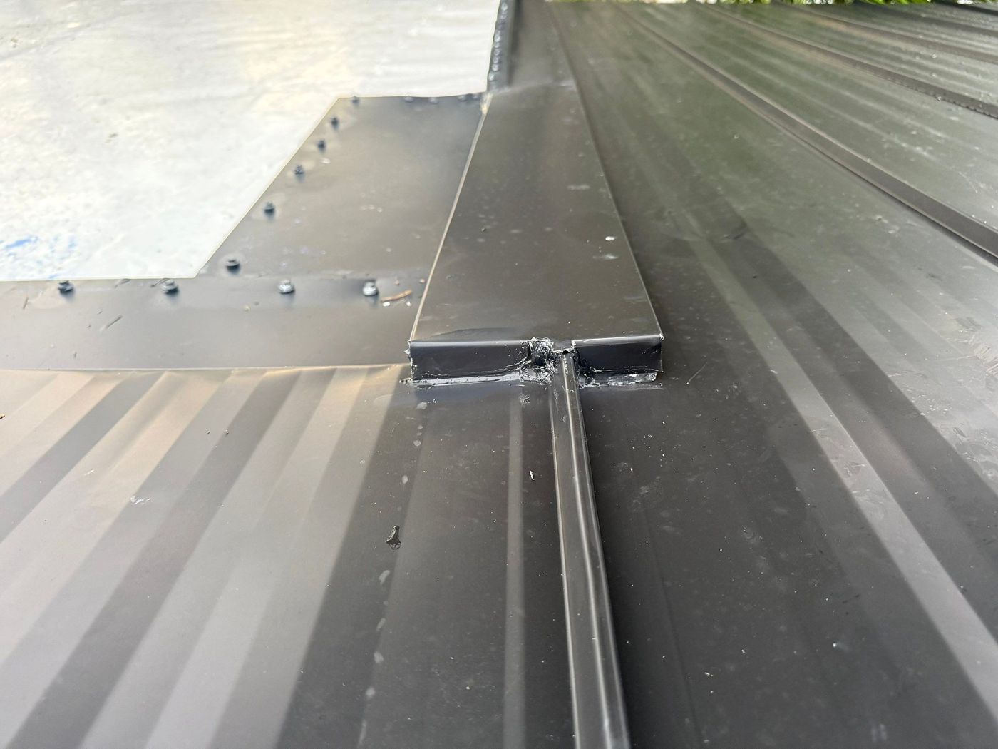 Close-up of a metal roof seam and flashing