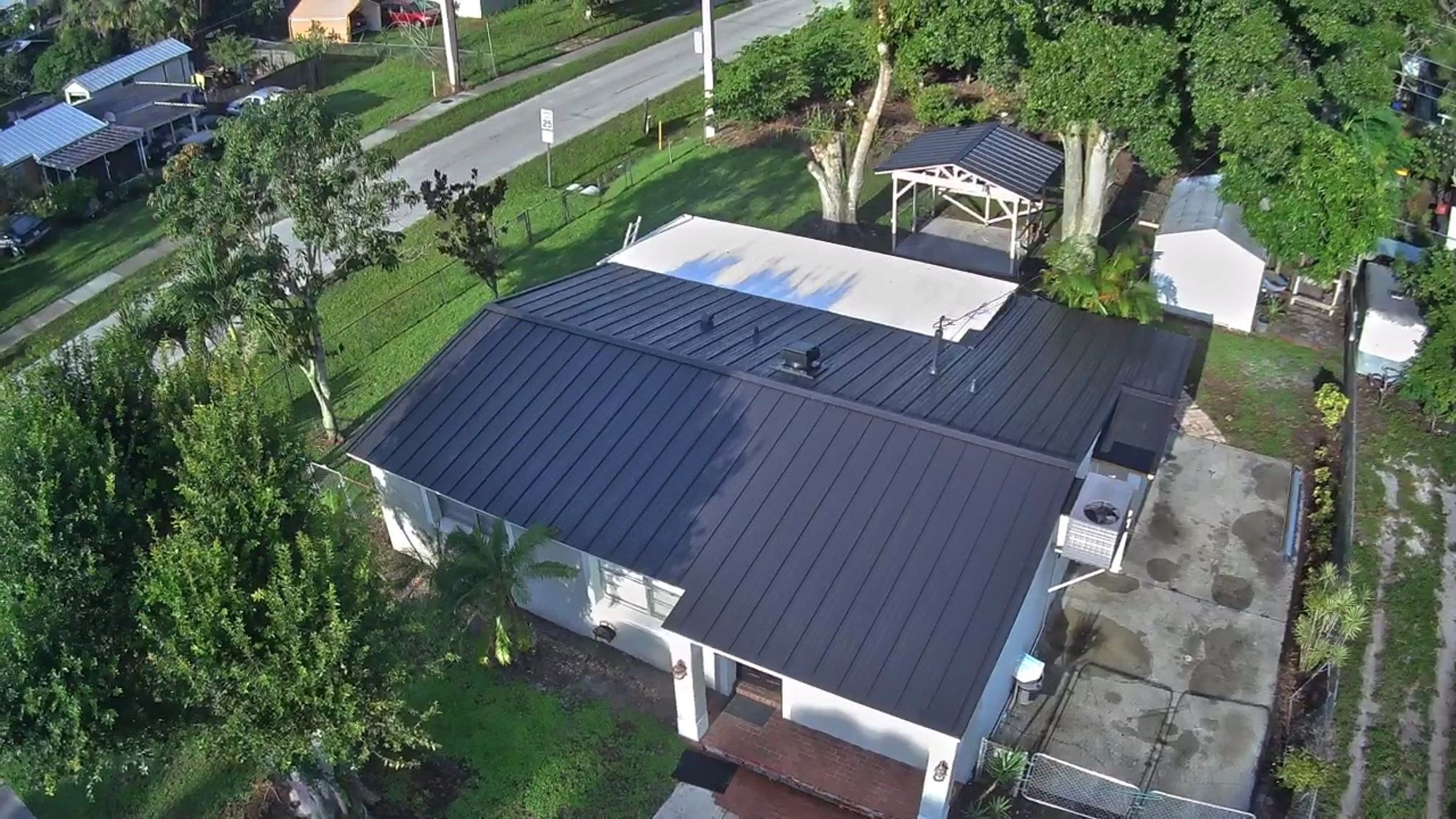 Aerial view of a home with a new black standing-seam metal roof